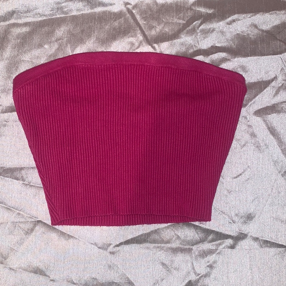 Hot pink ribbed tube top. Thick band at the top secures shirt from sliding down.